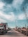 Cargo trucks lined up at a busy shipping port under clear skies
