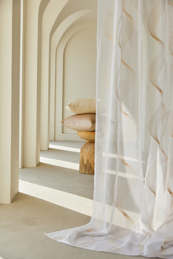 Floor-to-ceiling sheer curtains beside staircase