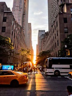 A vibrant street scene in New York City with yellow taxis and skyscrapers at sunset