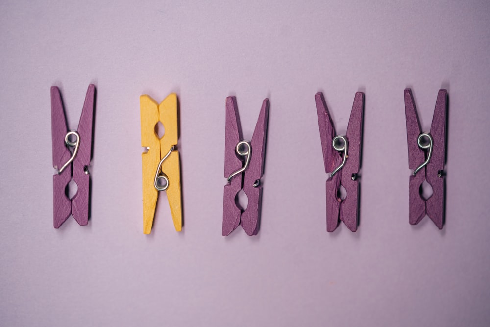 five yellow and silver clothes pin