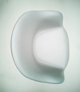 A smooth, modern chair with a minimalist design featuring curved edges and a shiny surface. The chair is predominantly white, set against a pale background, emphasizing its elegant and contemporary style.