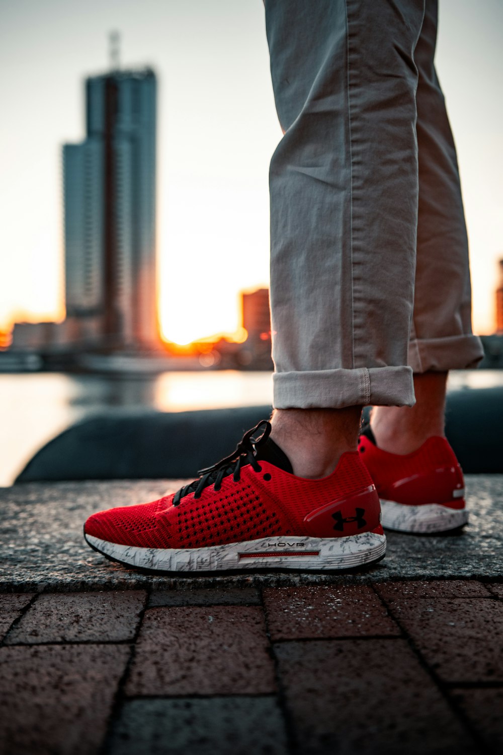 person in blue denim jeans and red nike sneakers