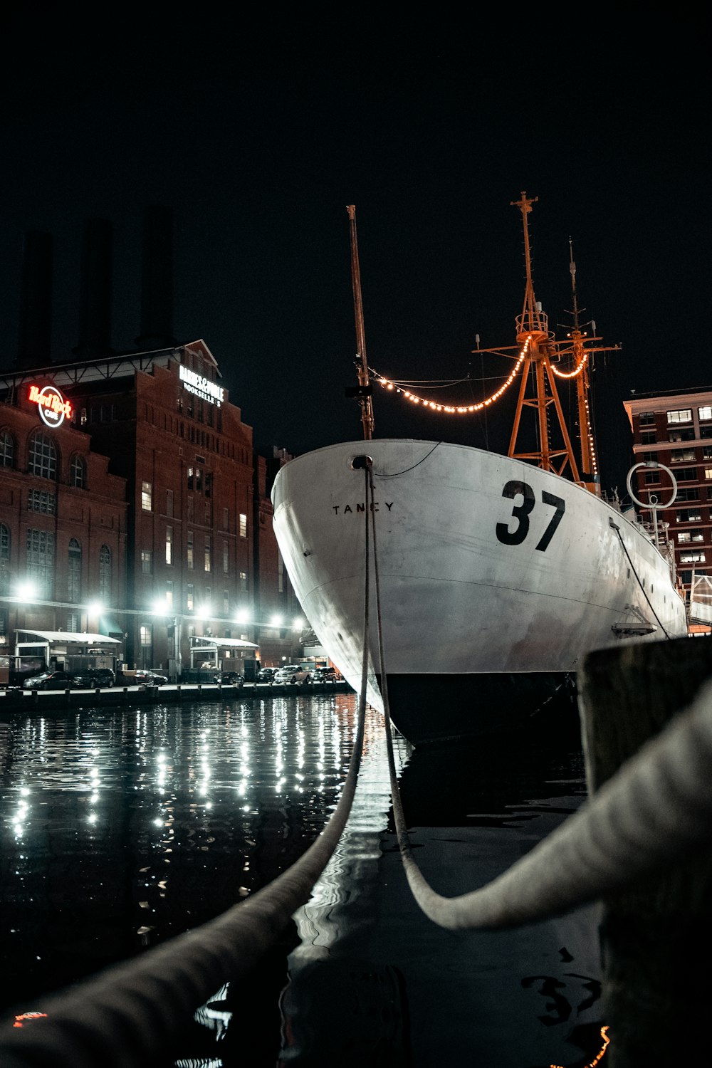 white and red ship on dock during night time