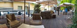 An outdoor patio area transformed with new flooring and comfortable seating