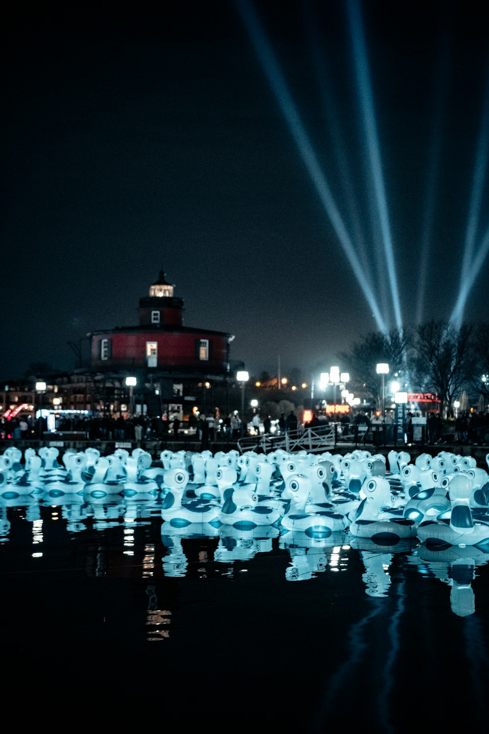 people in white shirt and black pants standing on ice field during night time