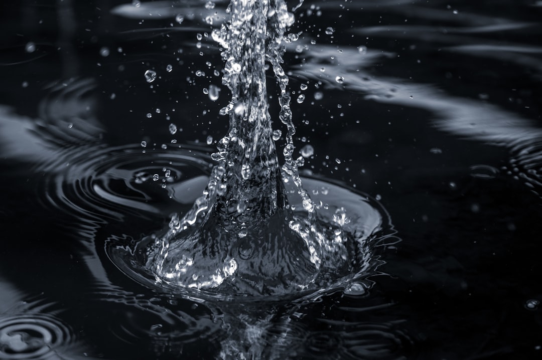 water splash in grayscale photography