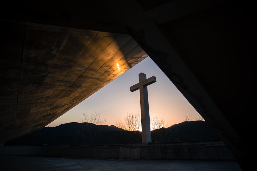 white cross on brown wooden dock during daytime