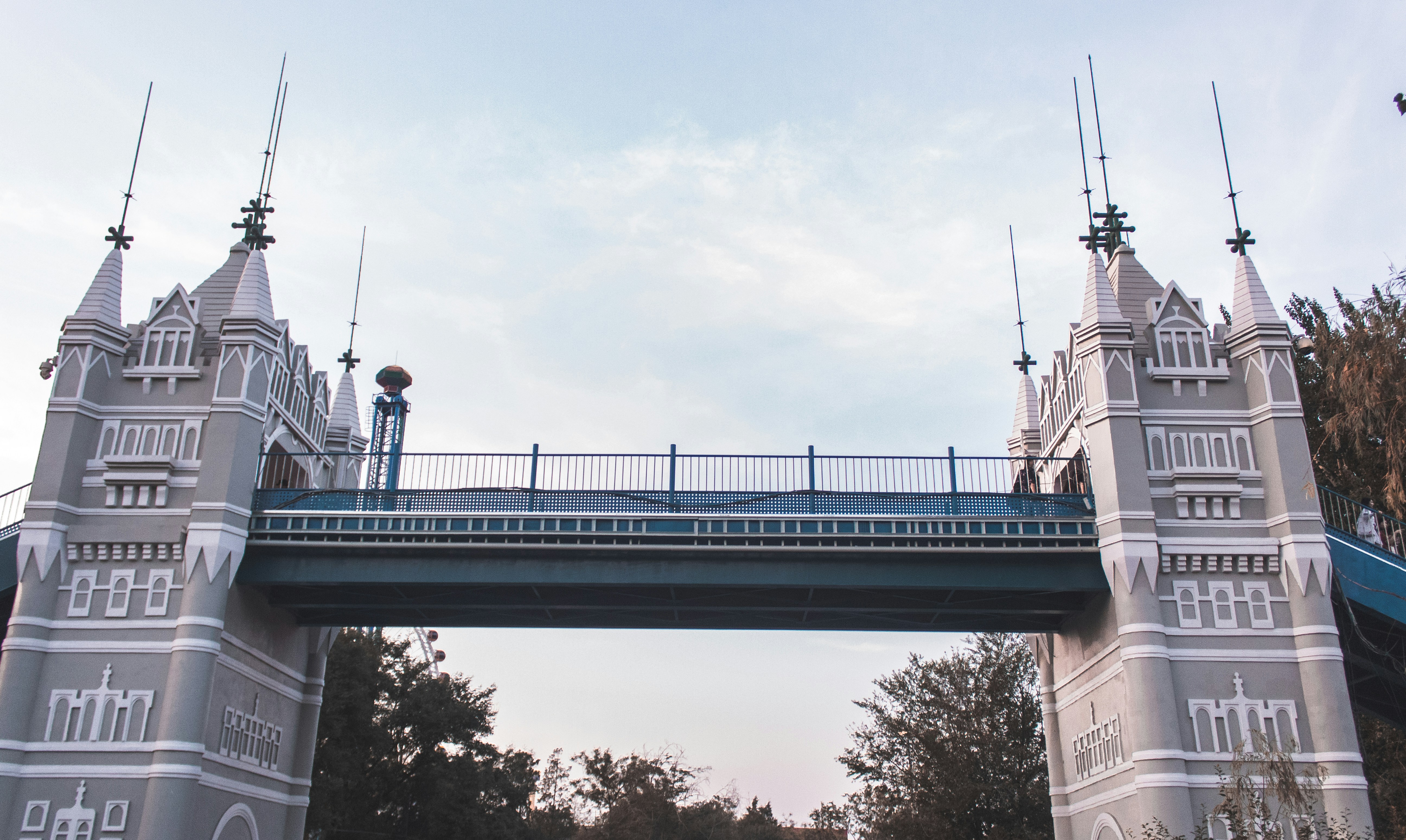 white and blue bridge under white sky during daytime