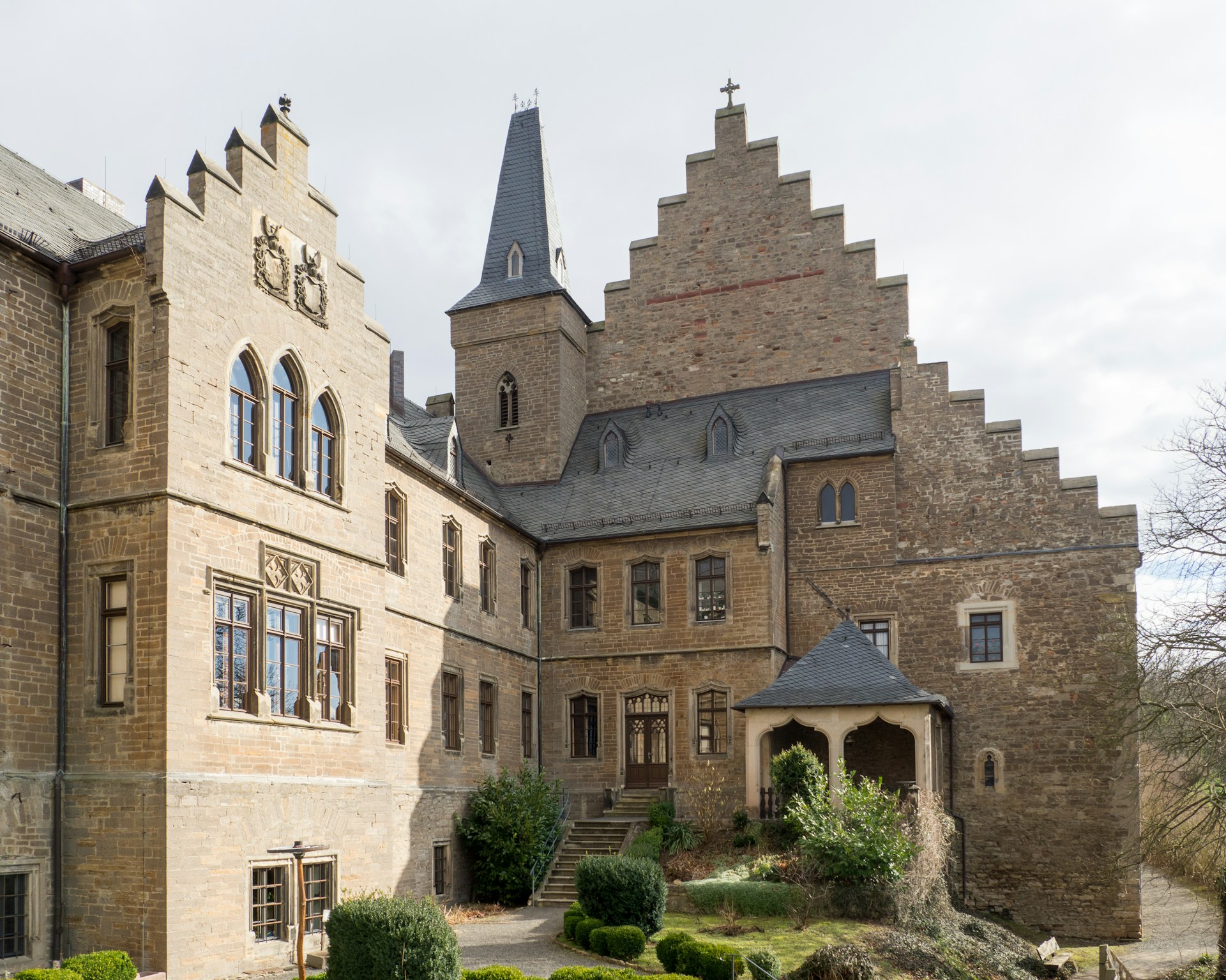 brown concrete building under white clouds during daytime