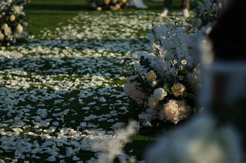 Ceremony aisle with white rose petals and candles