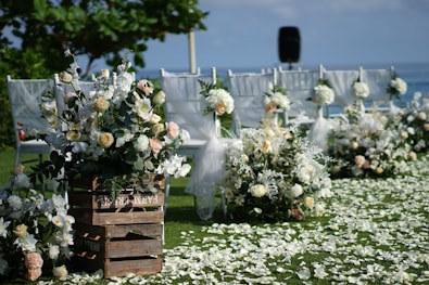 white and yellow flowers on brown wooden crate