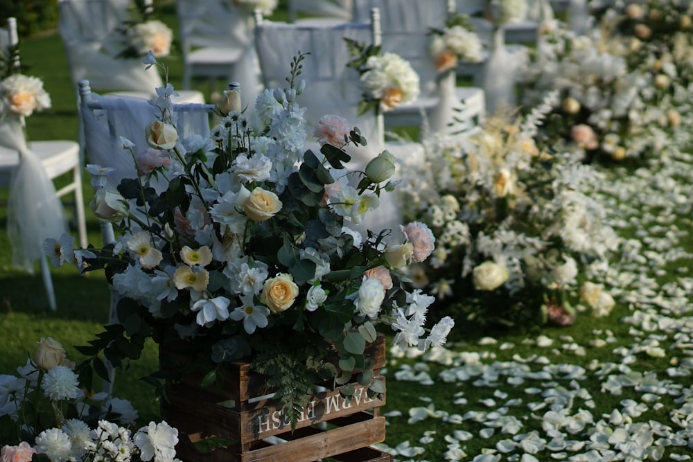 white and yellow flowers on brown wooden table