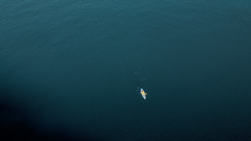 person surfing on blue sea during daytime