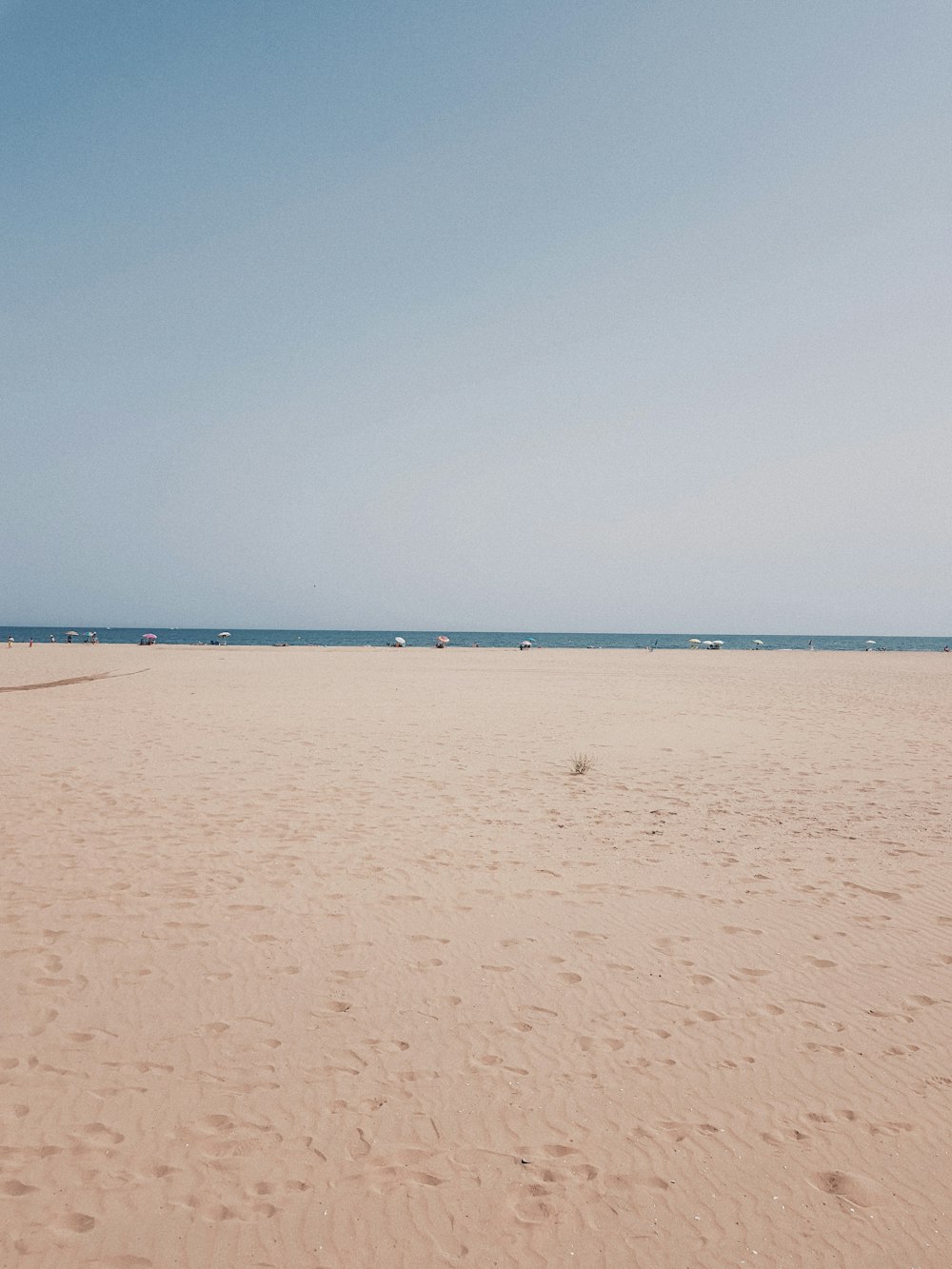 brown sand near body of water during daytime