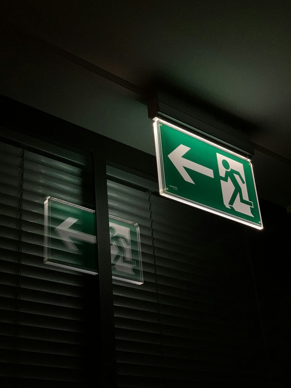 white and green exit sign