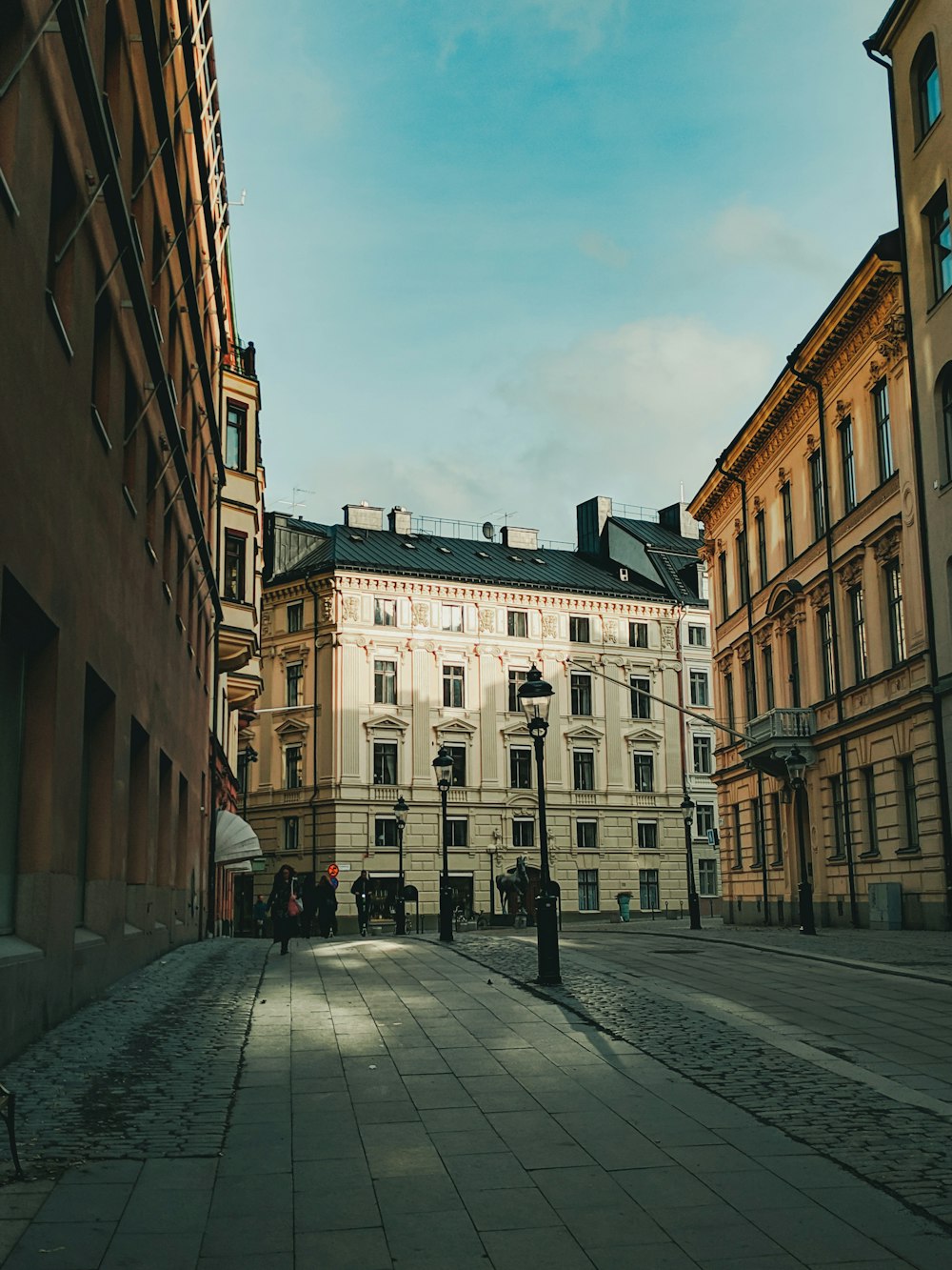 people walking on sidewalk near building during daytime