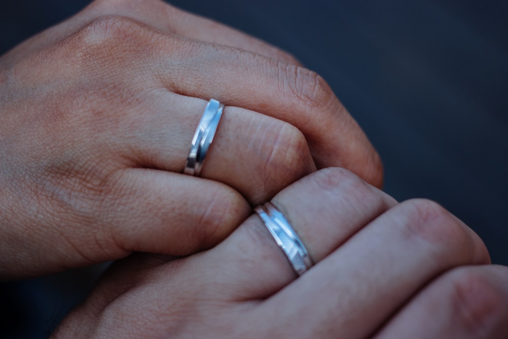 person wearing silver diamond ring