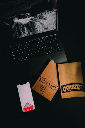 black laptop computer beside white card