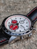 silver and black round chronograph watch