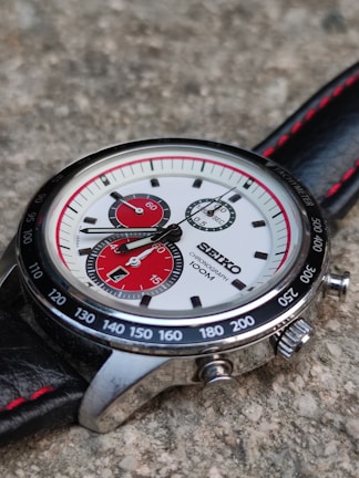 silver and black round chronograph watch