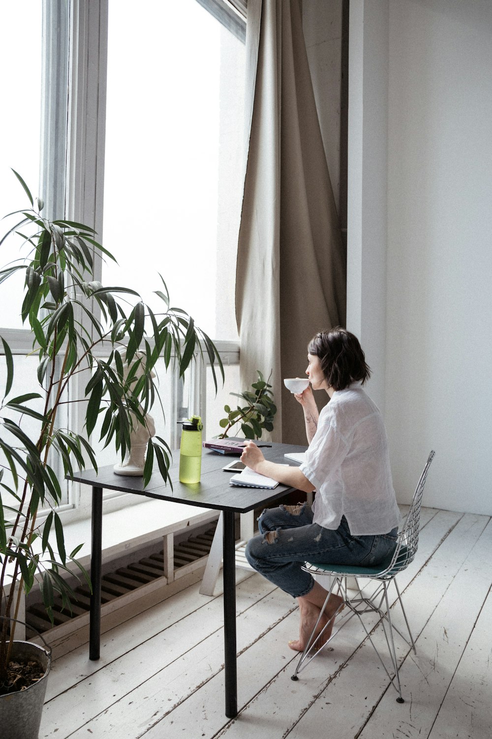 woman in white shirt sitting on chair in front of computer