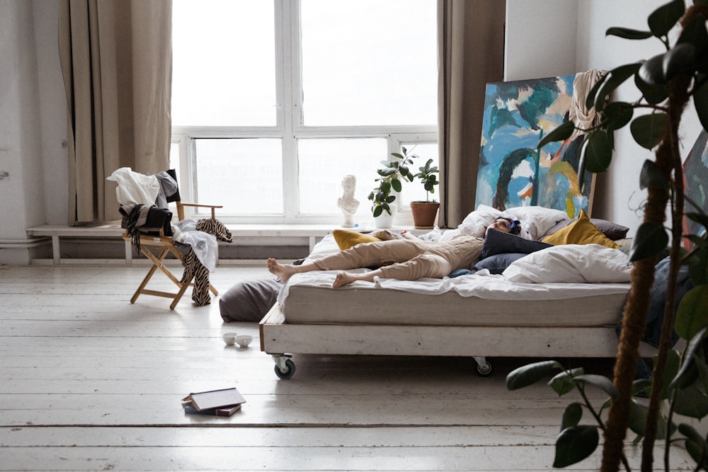 woman in white shirt lying on bed