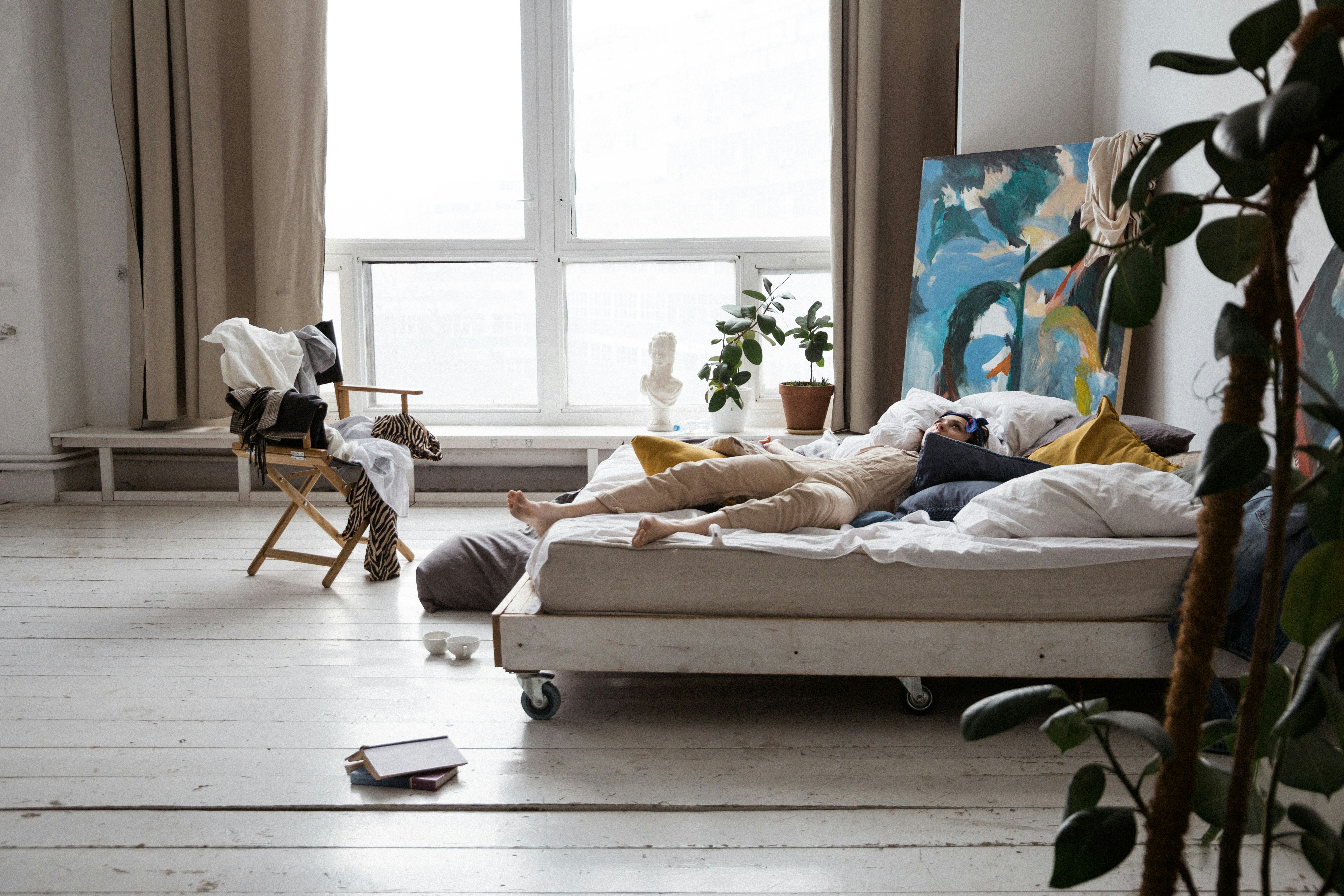 woman in white shirt lying on bed