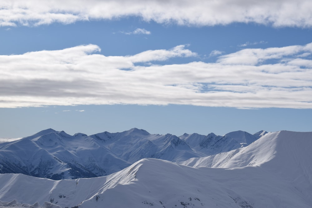 snow covered mountains under blue sky during daytime