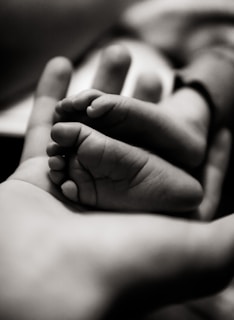grayscale photo of babys feet