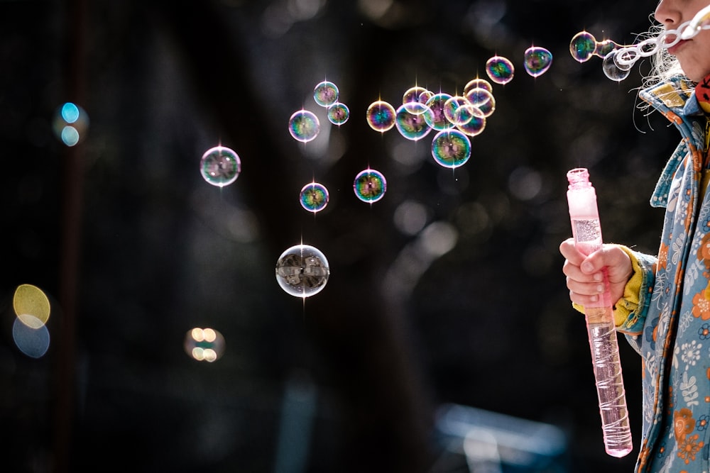 person holding bubbles during daytime