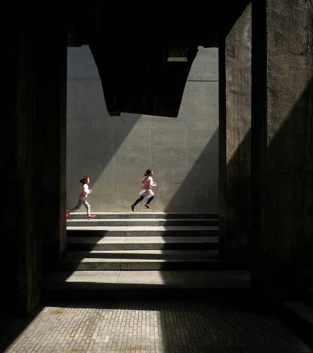 2 person walking on stairs