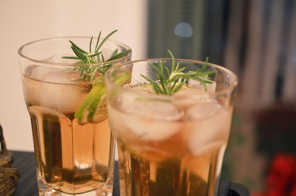 clear drinking glass with brown liquid