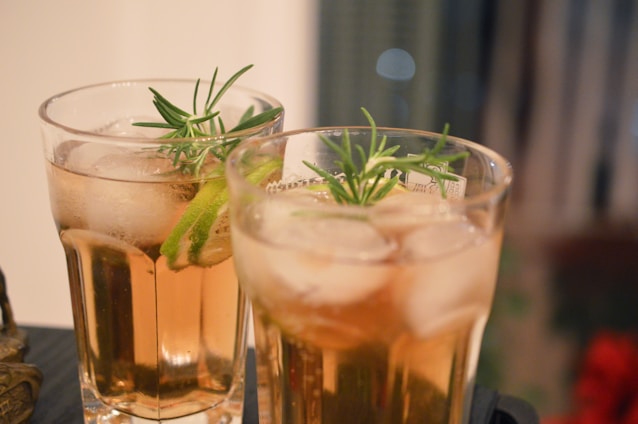 clear drinking glass with brown liquid