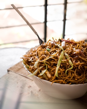 brown and green leaves on white ceramic bowl