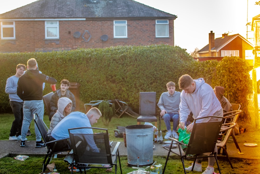 people sitting on chair near brown brick wall during daytime