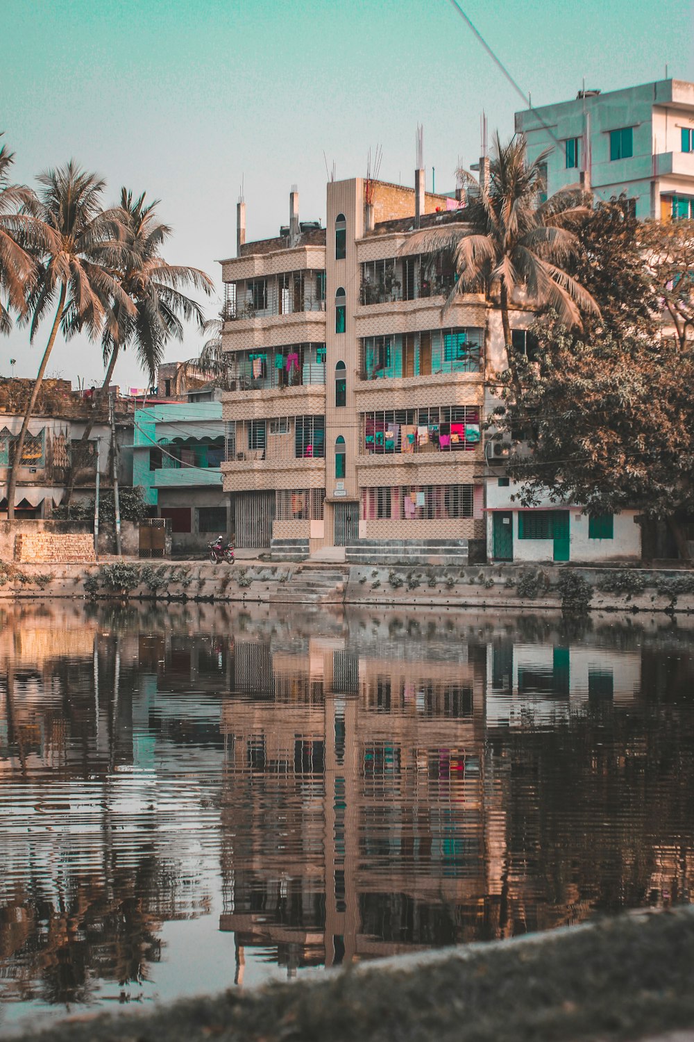 brown and white concrete building near body of water during daytime