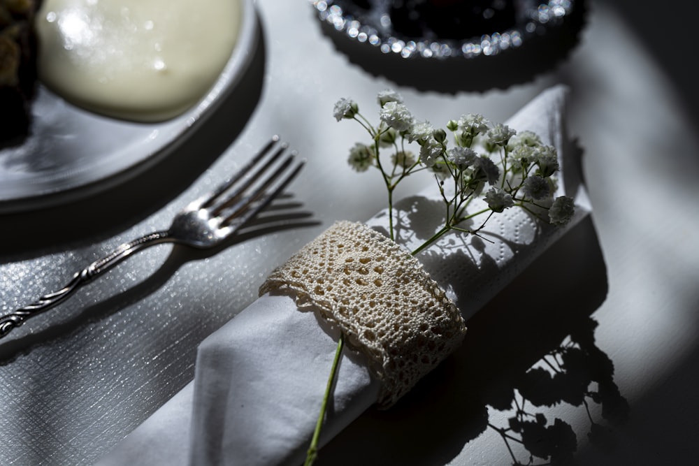 stainless steel fork beside white ceramic plate with white cream