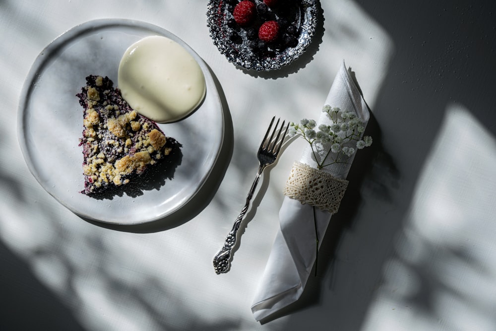 stainless steel fork and knife on white ceramic plate