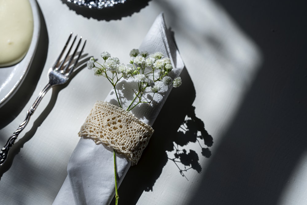 stainless steel fork and bread knife on white table cloth