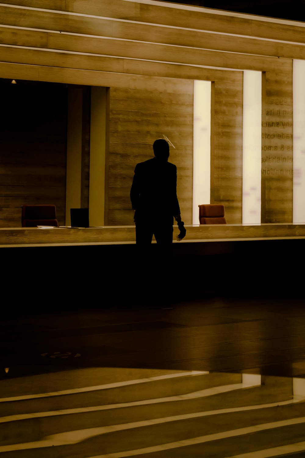 silhouette of person standing on hallway