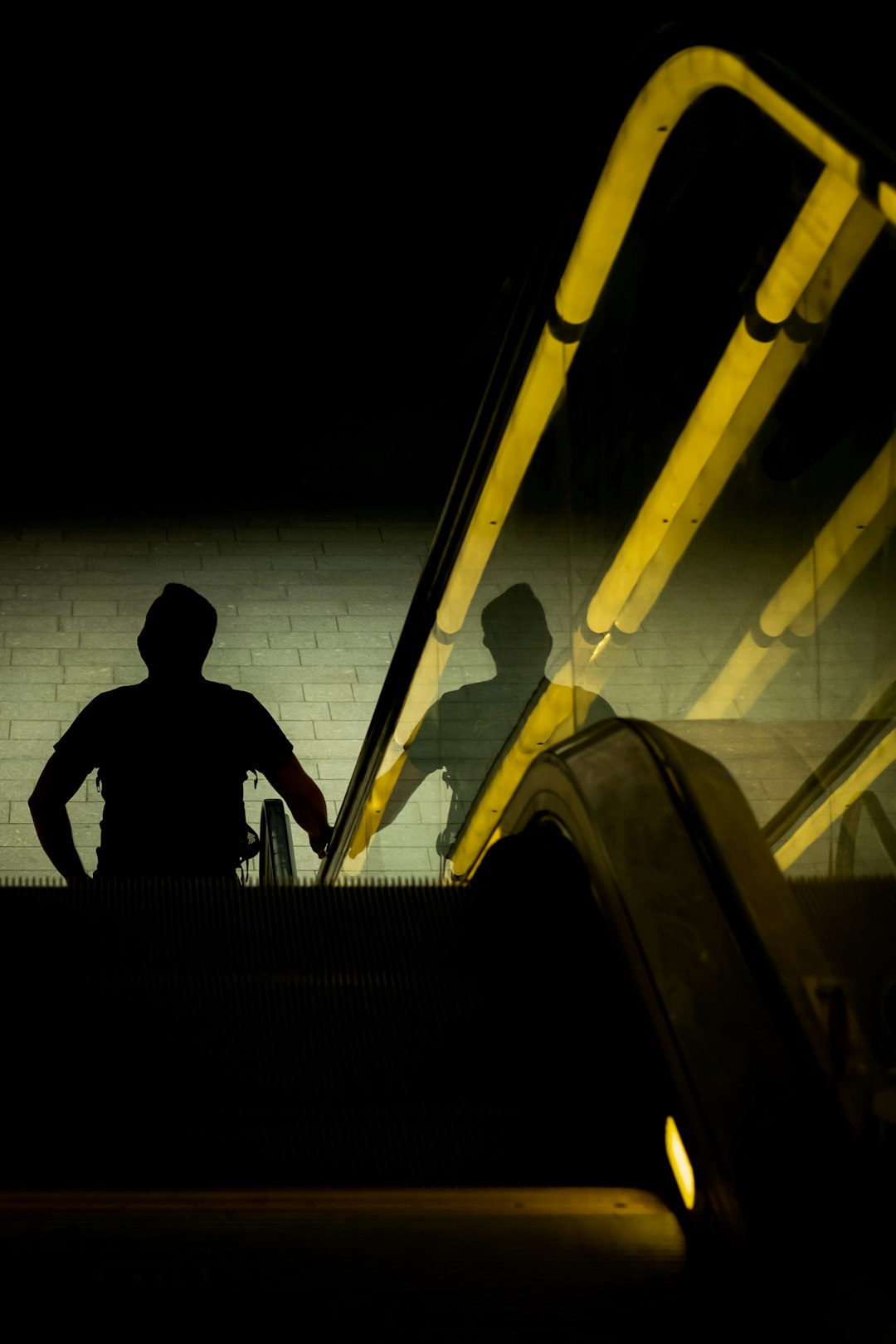 silhouette of man sitting on stairs