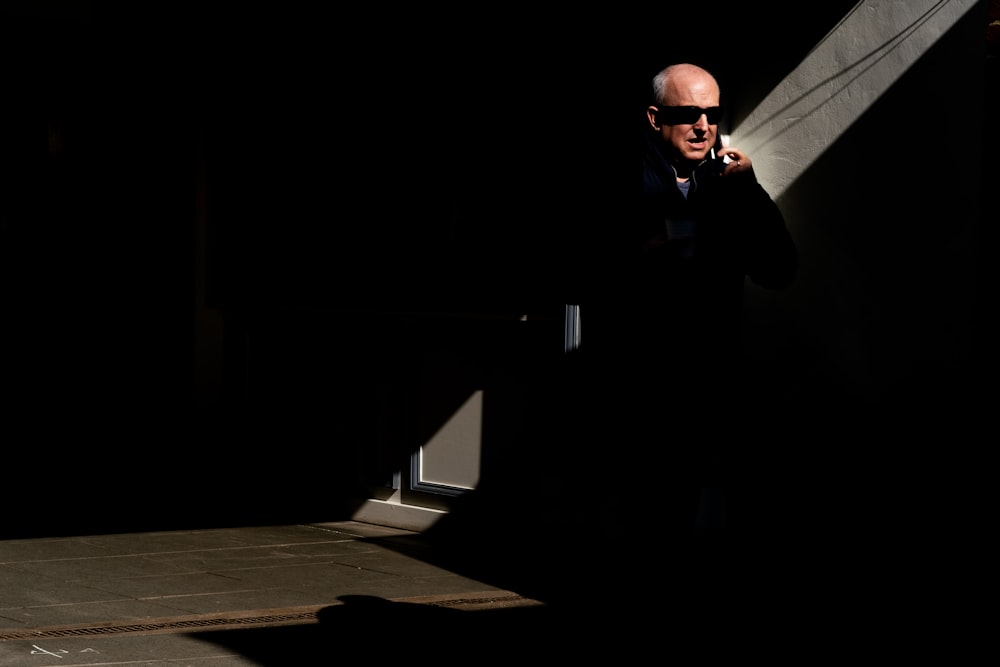 man in black jacket wearing black sunglasses