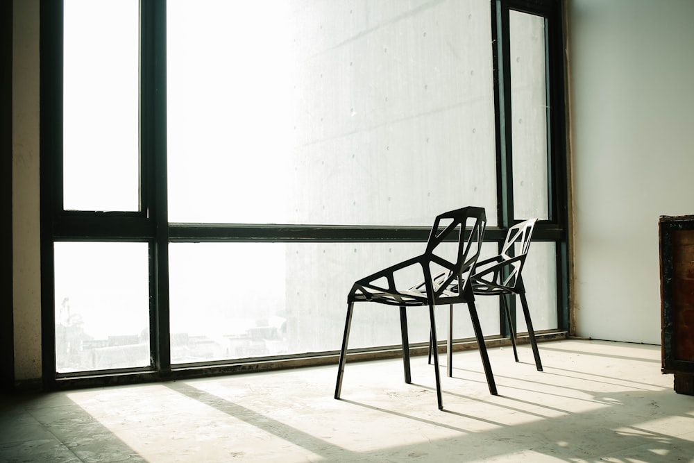 black wooden chair beside glass window