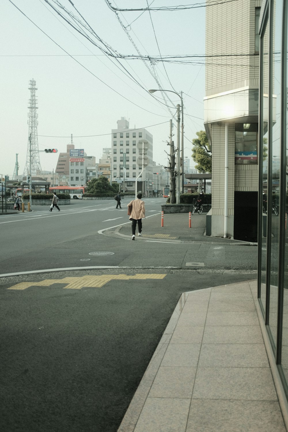 woman in black jacket and black pants walking on sidewalk during daytime