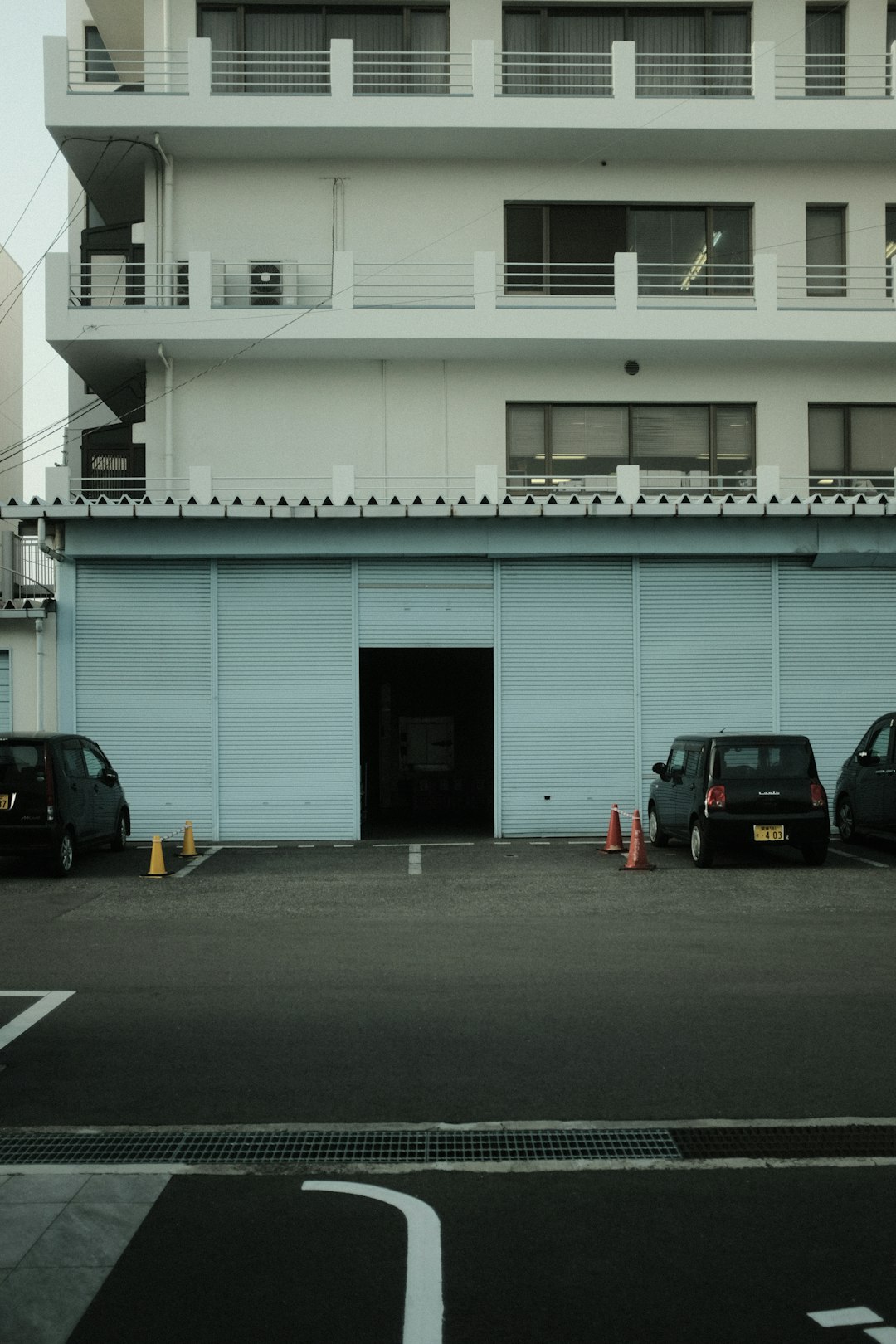 black suv parked beside white building