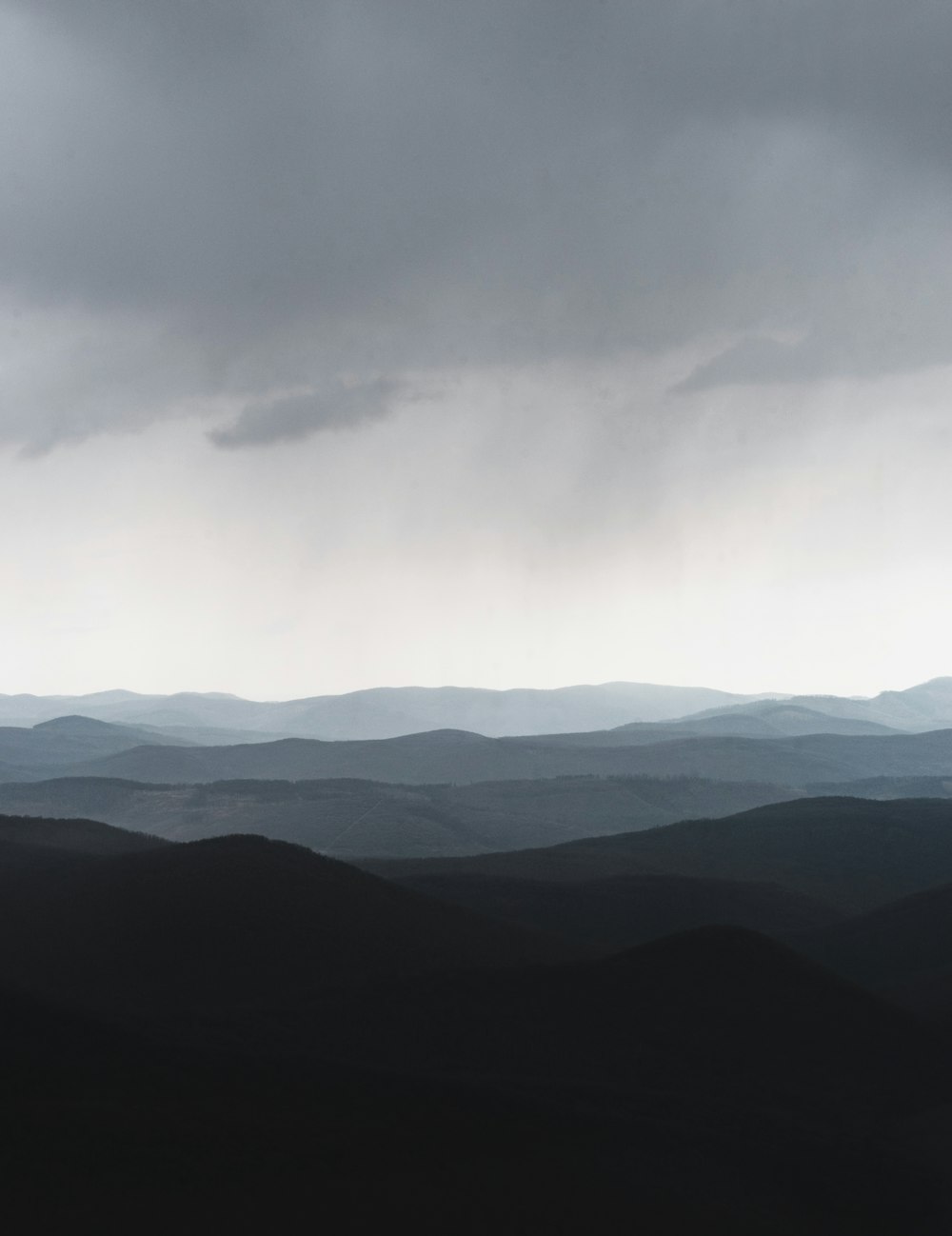 mountains under white clouds during daytime