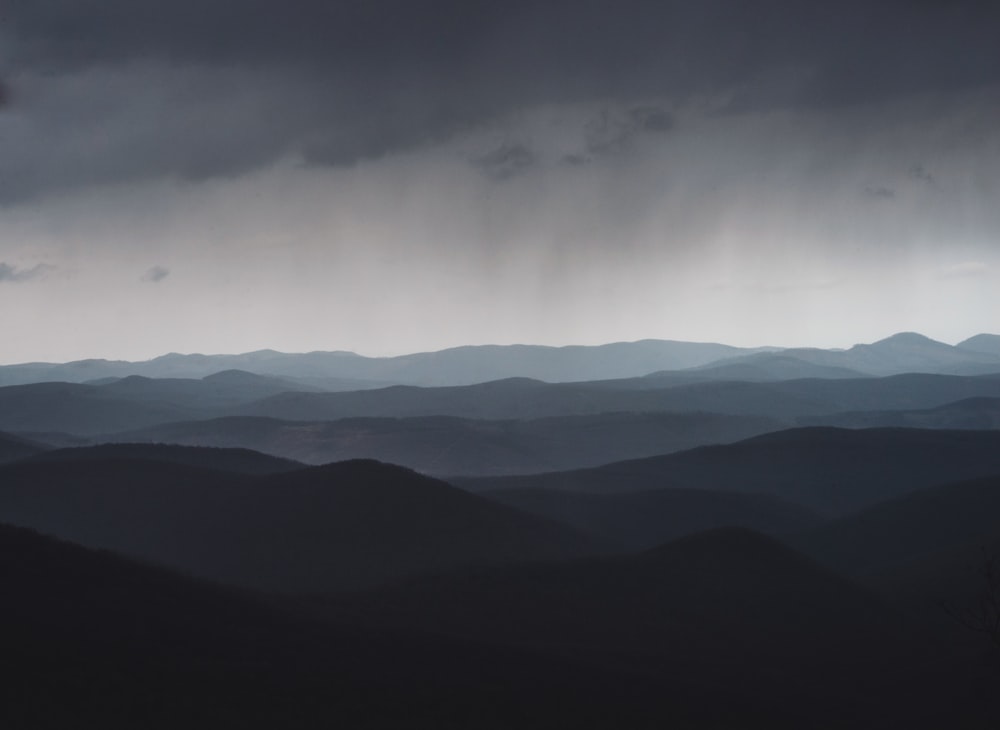 mountains under white clouds during daytime