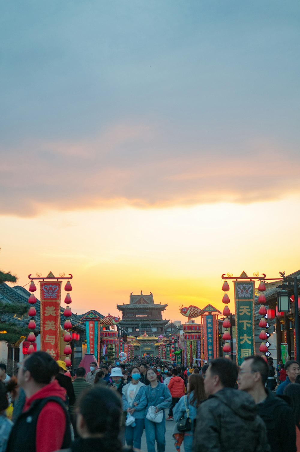 people walking on street during sunset