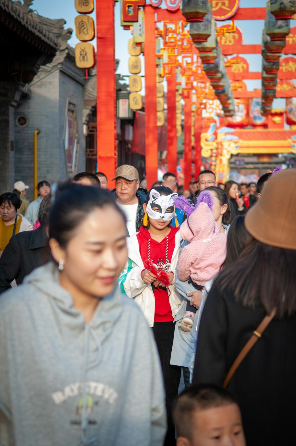 man in gray polo shirt wearing white mask