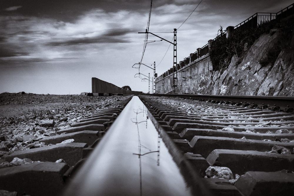 gray concrete road near body of water